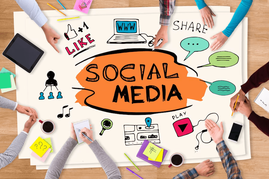 7 Best Social Media Management Strategies For Businesses 2 a group of people sitting around a table with a social media drawing on it focusing on social media management